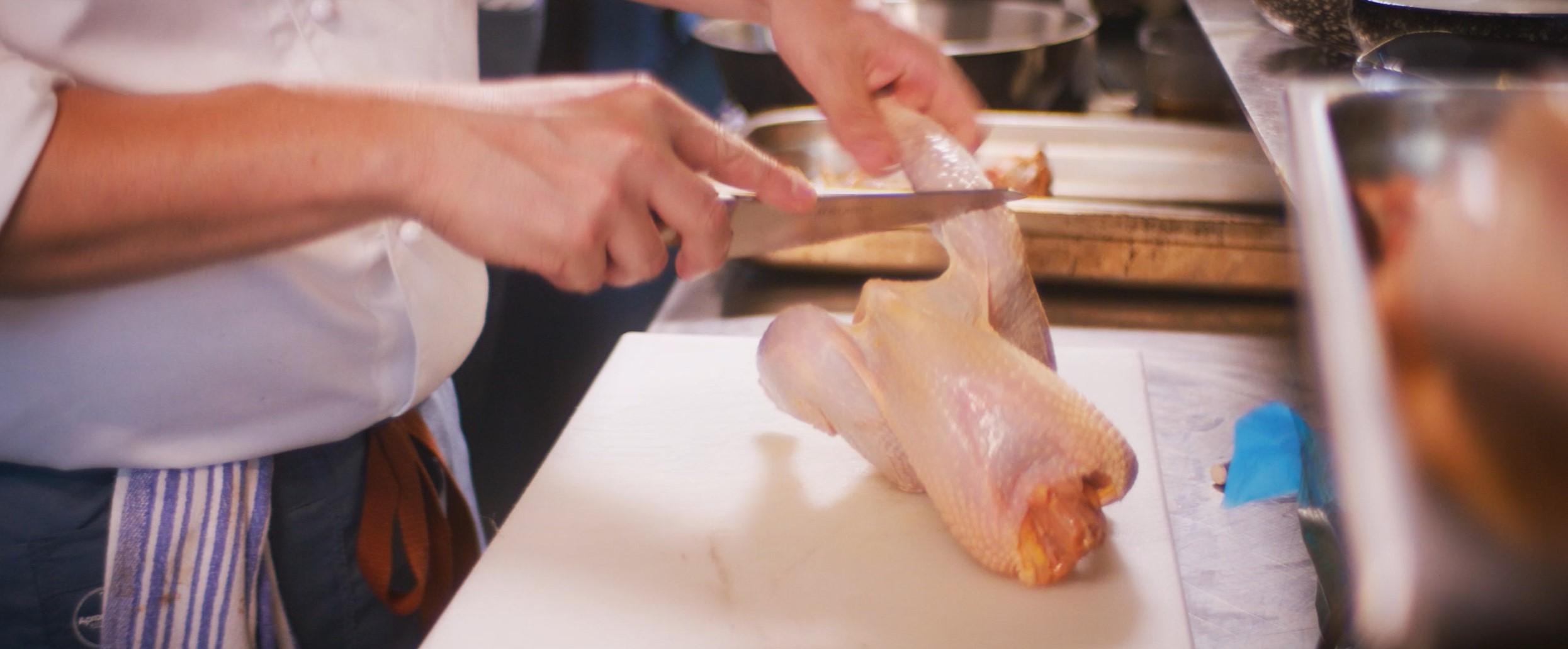 chef cutting chicken