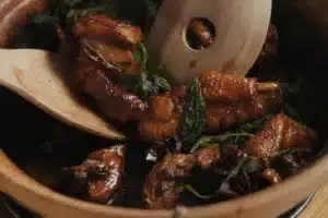 Tossing shiso through glazed 3 cup Aurum Cockerel in a hot claypot